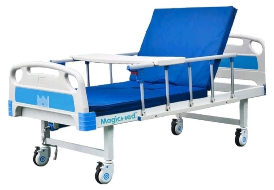 Manual hospital cot with side rails, over-bed table and castor wheels